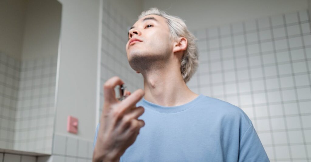 A stylish young man applying perfume in a contemporary bathroom setting, embracing a metrosexual lifestyle.